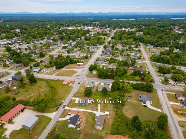 611 South Walnut Street Seneca, SC 29678 - Photo 29 of 31 An aerial view captures the vibrant community with its lush green landscape and Lake Keowee not far away.