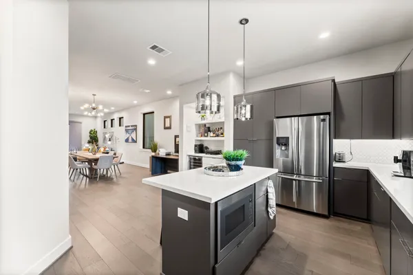 a kitchen with a refrigerator a oven and a sink