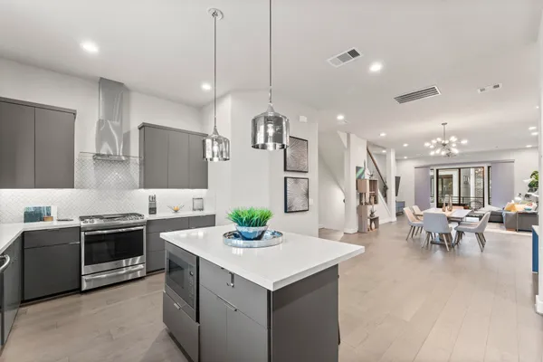 a kitchen with a sink a counter top space and stainless steel appliances