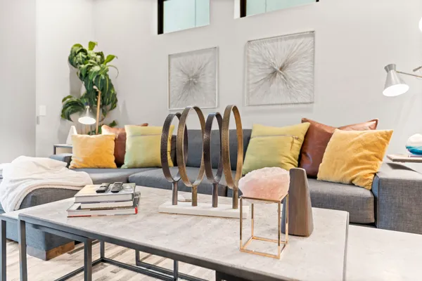a living room with furniture flowerpot and wooden floor