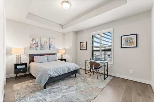 a bedroom with a bed chair and a window