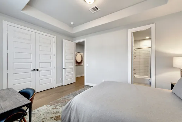 a bedroom with a bed and cabinets