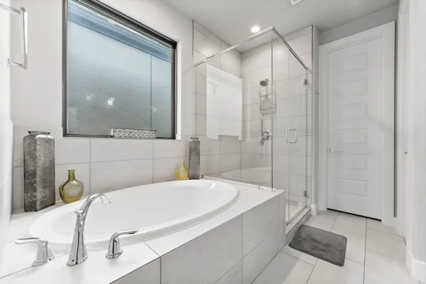 a bathroom with a bathtub and a shower
