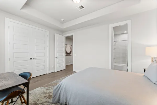 a bedroom with a bed and a table