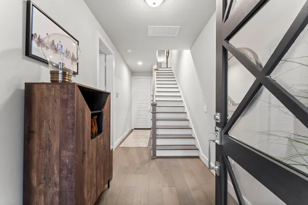 a view of entryway and hall with wooden floor