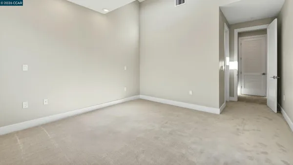 a view of an empty room and closet area