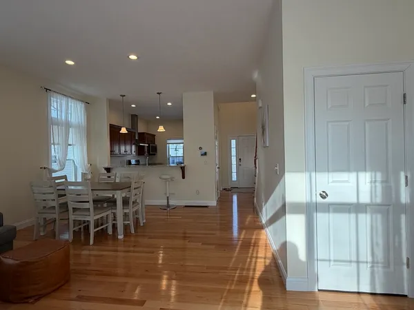 a view of a dining hall with dining room and wooden floor