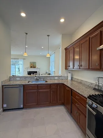 a kitchen with stainless steel appliances granite countertop a sink and stove top oven