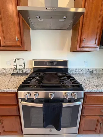 a stove top oven sitting inside of a kitchen