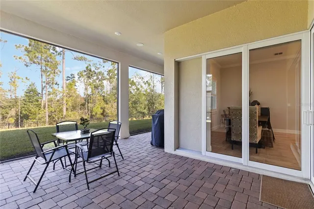 an aerial view of a house with a garden and lake view