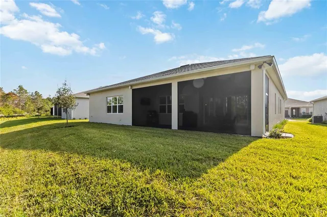 an aerial view of a houses with a lake