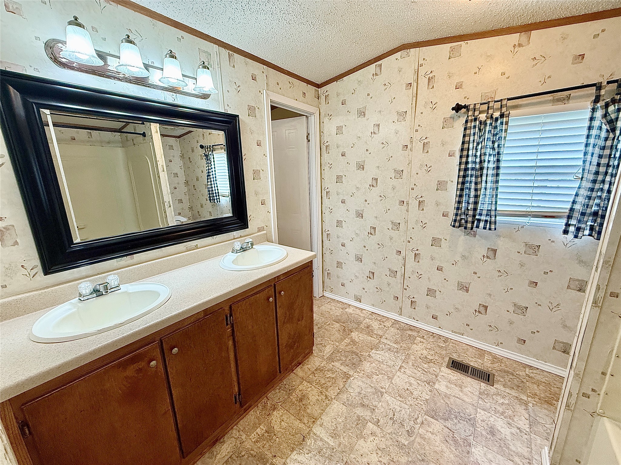 3075 FM 2001 Buda, TX 78610 - Photo 14 of 26 Double vanity and large mirror anchor this functional bathroom with easy-care flooring.