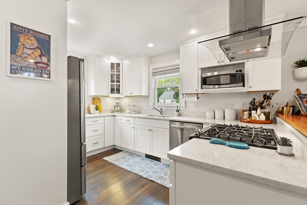 61 Howitt Road Boston, MA 02132 - Photo 16 of 42 a kitchen with a sink stove and microwave
