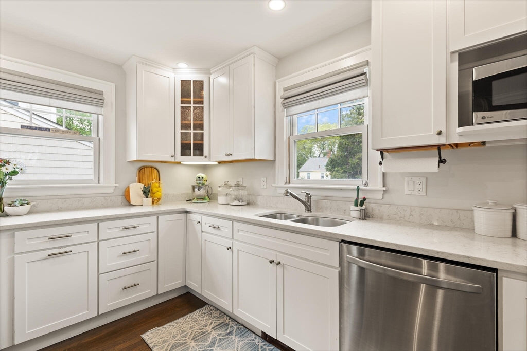 61 Howitt Road Boston, MA 02132 - Photo 19 of 42 a kitchen with white cabinets and a window