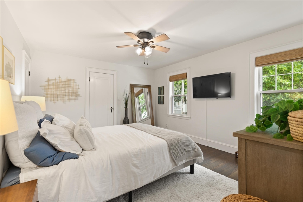 61 Howitt Road Boston, MA 02132 - Photo 25 of 42 a bedroom with a bed window and a flat screen tv