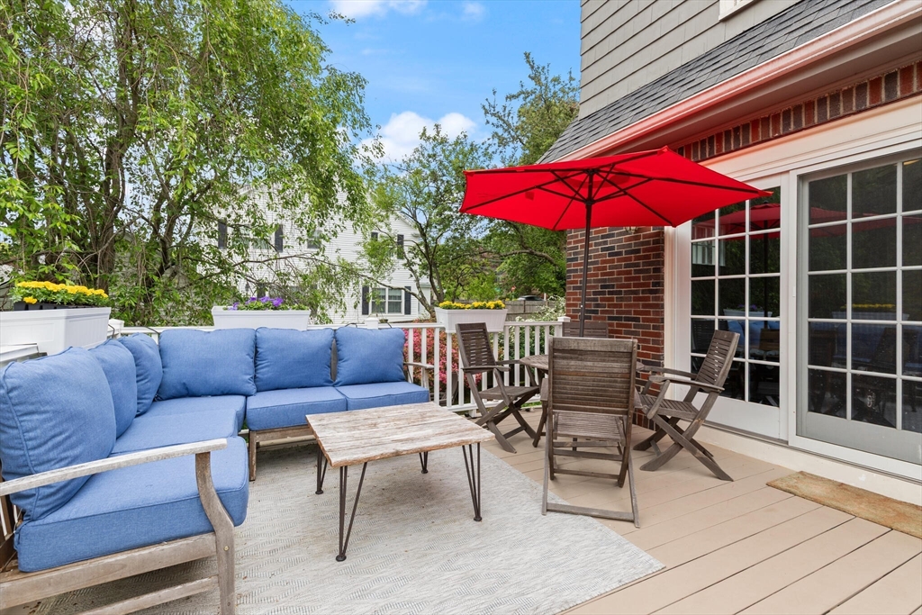 61 Howitt Road Boston, MA 02132 - Photo 31 of 42 a view of a chairs and table in the back yard of the house