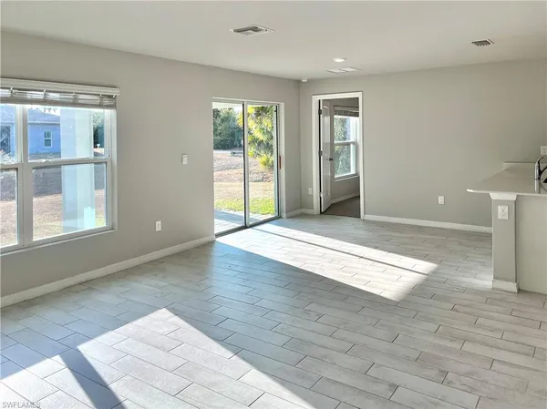 an empty room with closet and windows