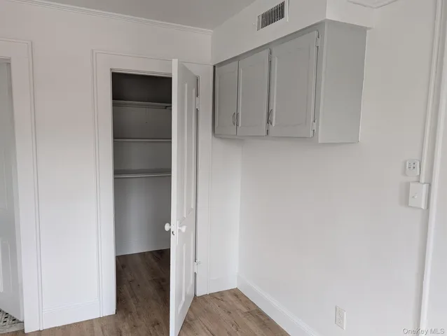 a view of walk in closet with empty racks