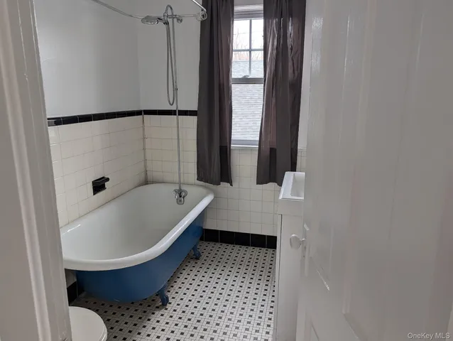 a bathroom with a bathtub and shower