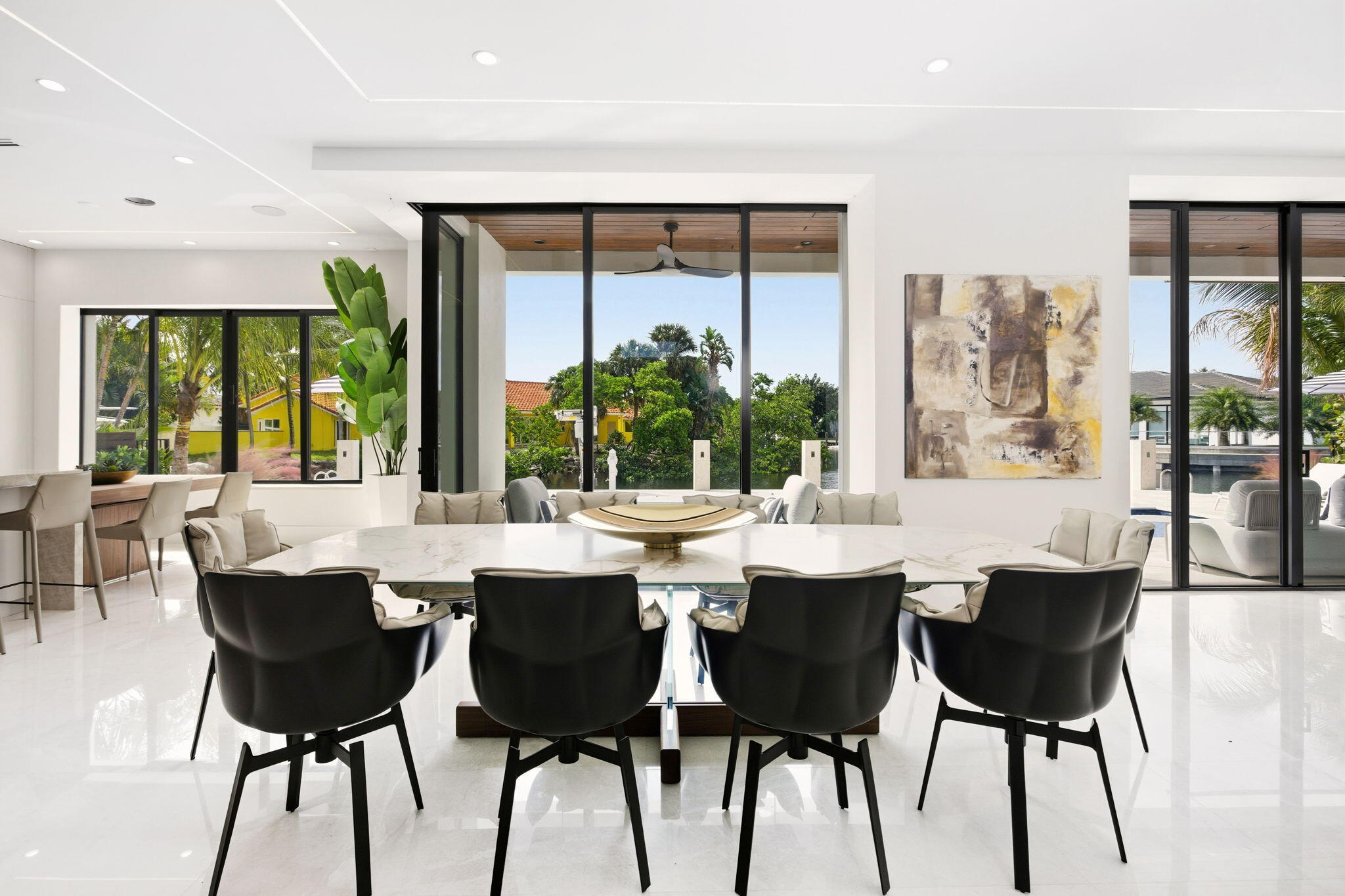 798 Havana Drive Boca Raton, FL 33487 - Photo 12 of 76 a dining room with furniture a large window and wooden floor