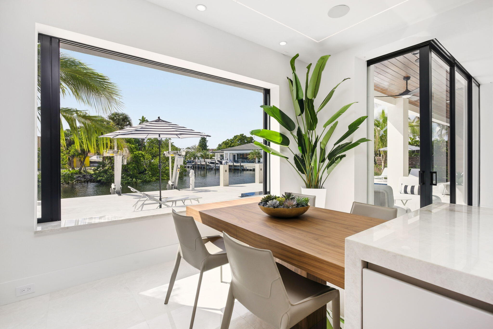 798 Havana Drive Boca Raton, FL 33487 - Photo 18 of 76 a dining room with furniture a large window and a chandelier