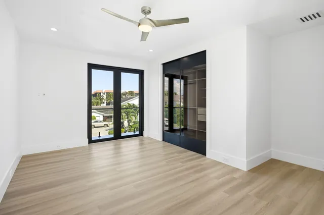 a view of swimming pool with red chairs