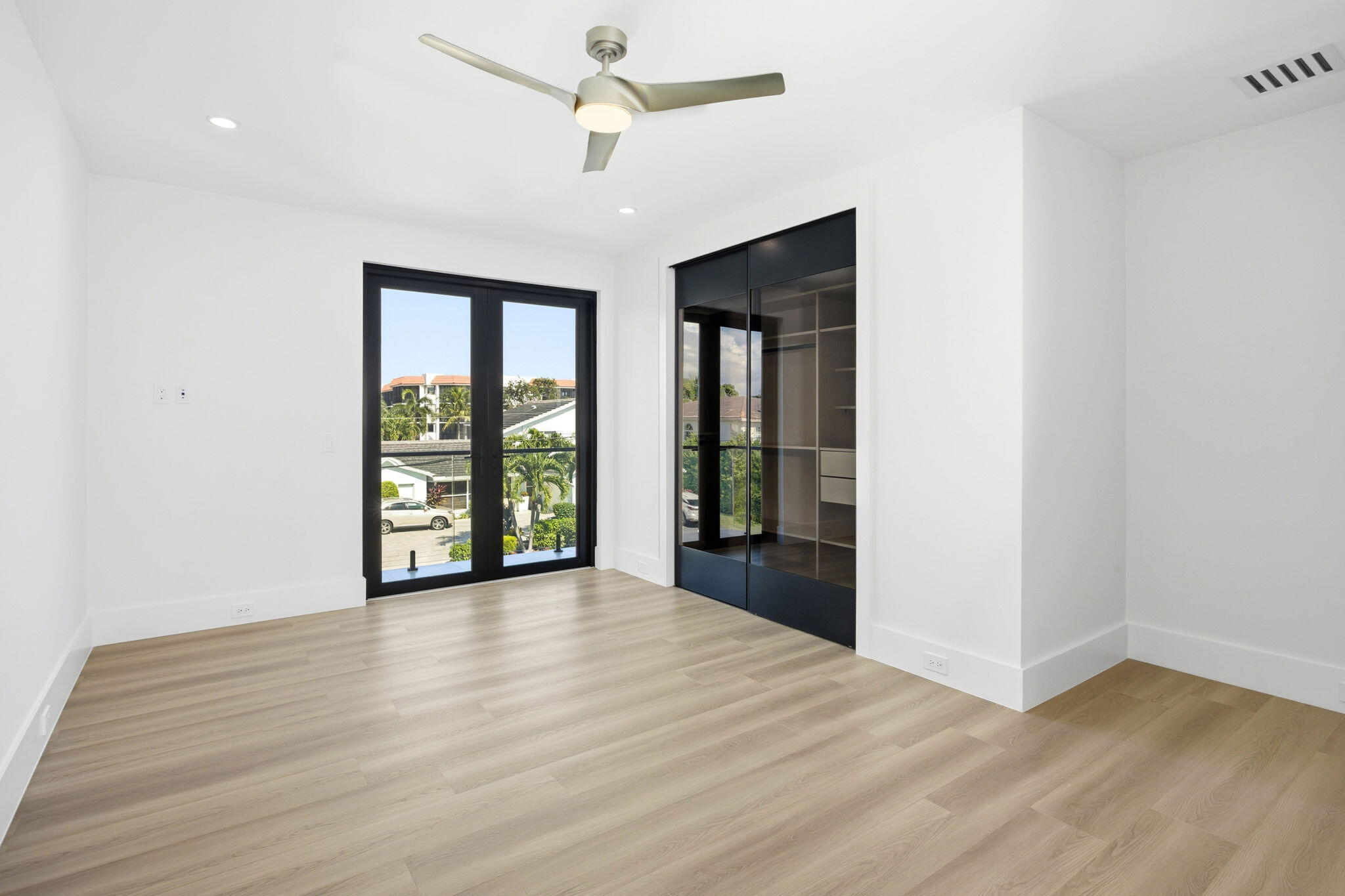 798 Havana Drive Boca Raton, FL 33487 - Photo 49 of 76 a view of an empty room with wooden floor and a window
