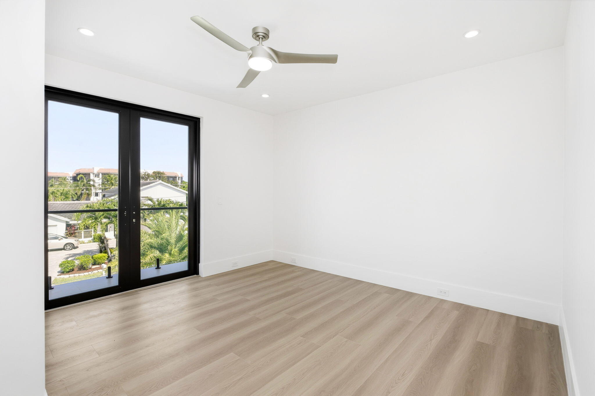 798 Havana Drive Boca Raton, FL 33487 - Photo 51 of 76 an empty room with wooden floor and windows