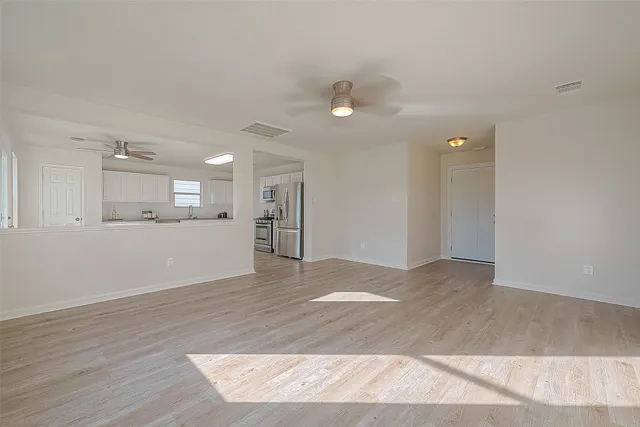 a view of a kitchen and an empty room