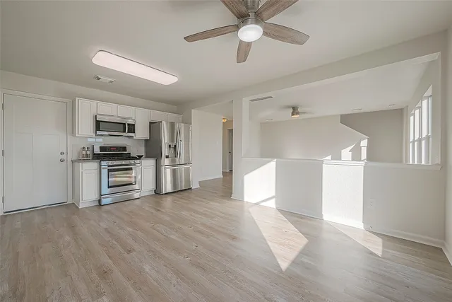 a view of kitchen with sink and refrigerator