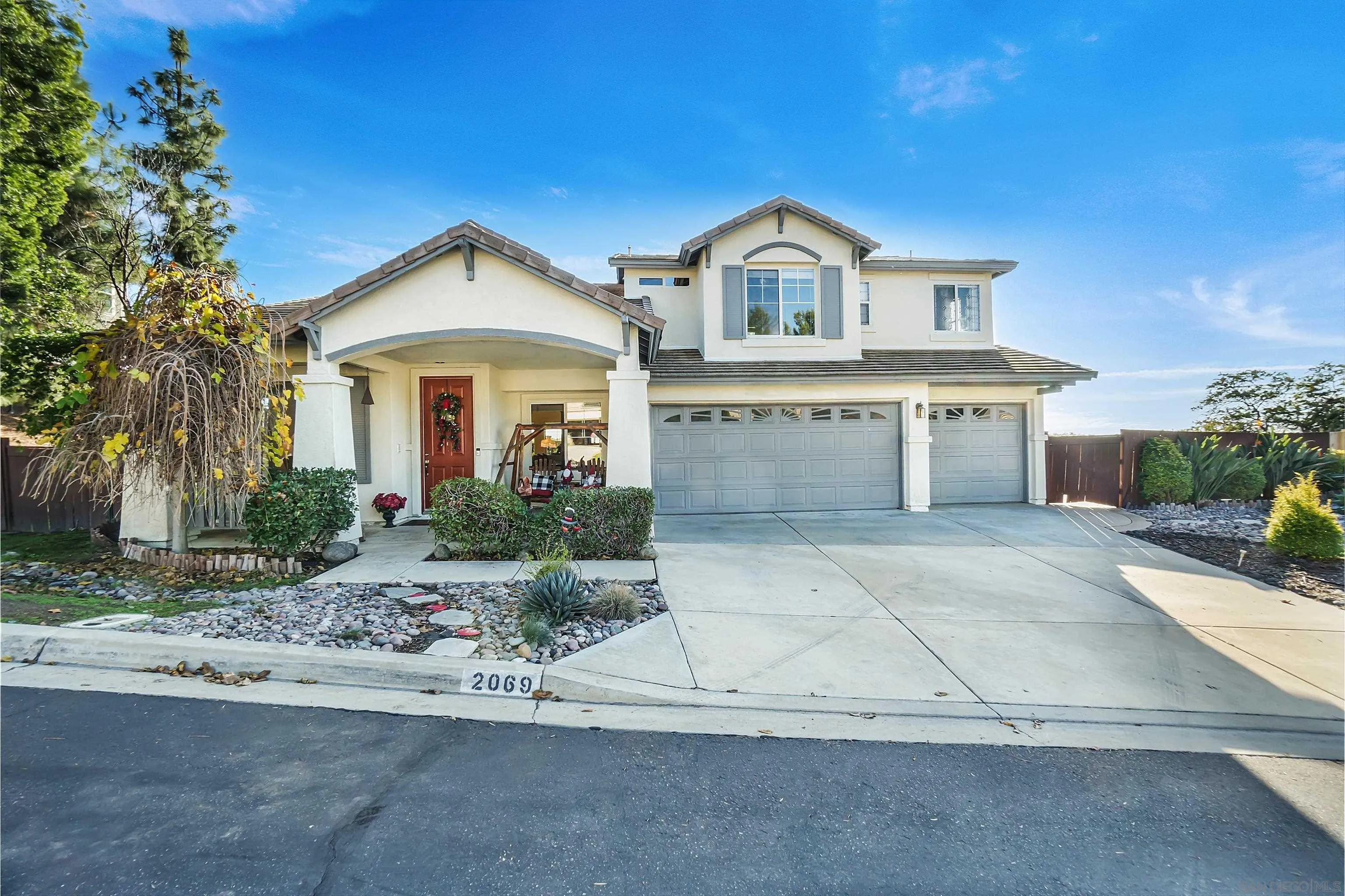 2069 Boulders Road Alpine, CA 91901 - Photo 1 of 13 a front view of a house with a yard and garage