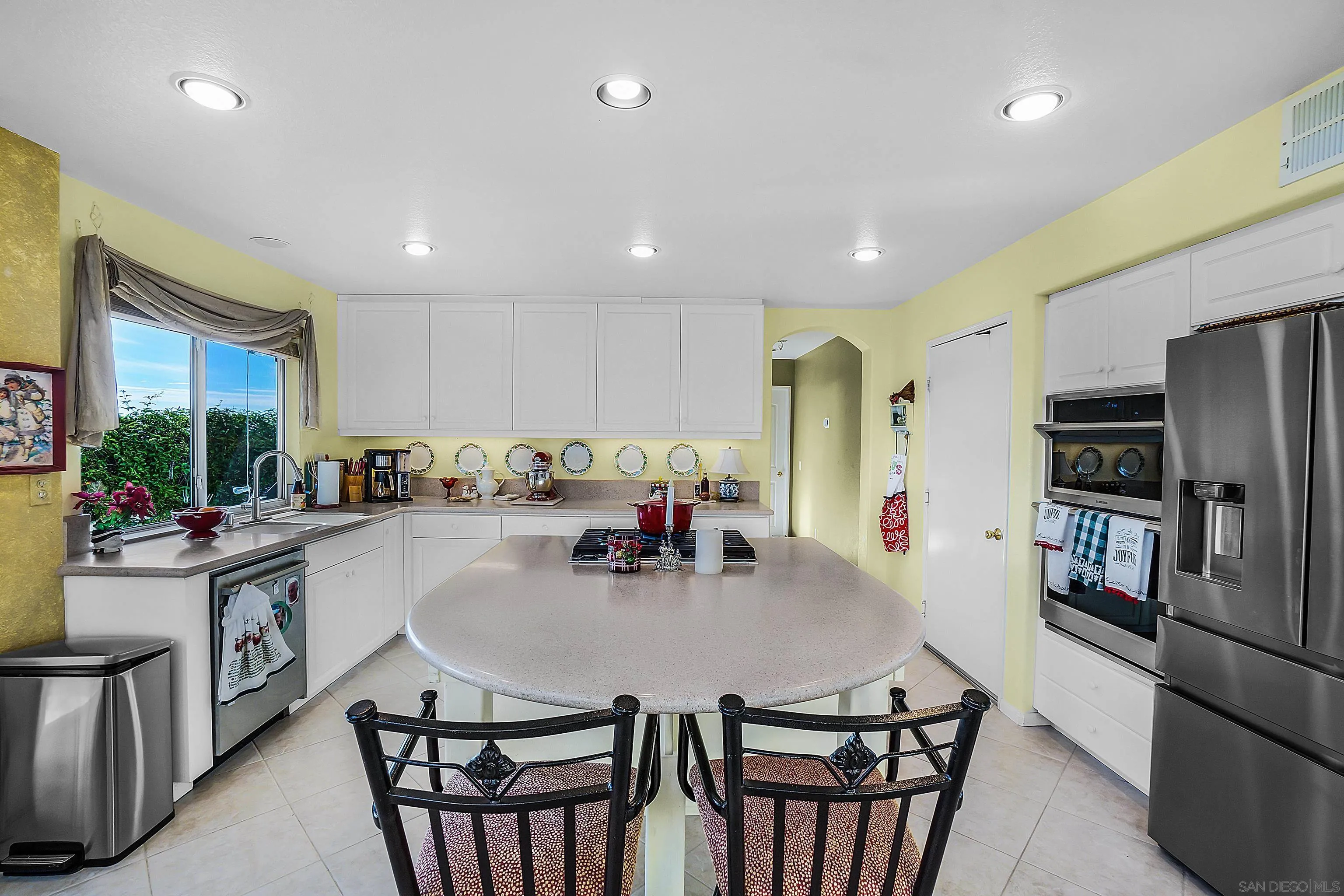 2069 Boulders Road Alpine, CA 91901 - Photo 4 of 13 a kitchen with stainless steel appliances a dining table chairs and refrigerator