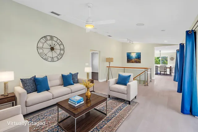 a living room with furniture a rug and a window