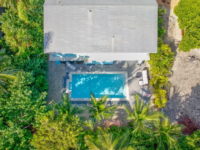 an aerial view of a house with a lake view