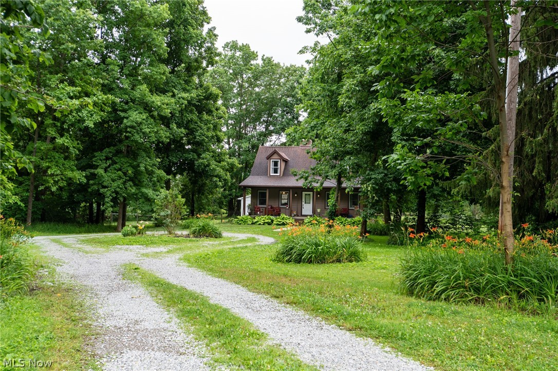 14027 Mayfield Road Huntsburg, OH 44046 - Photo 6 of 50 Gravel driveway, surrounded by manicured lawns and mature trees