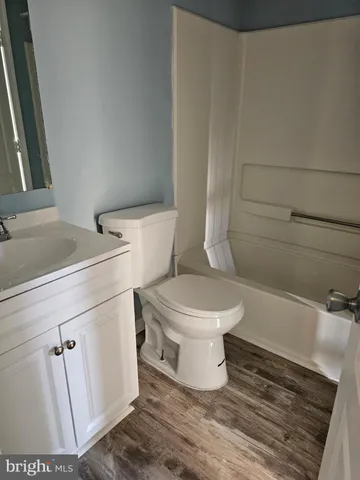 a white toilet sitting next to a bathroom sink