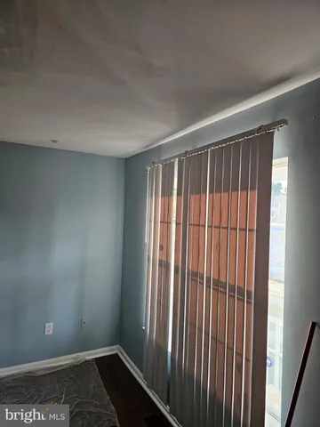 a view of a room with a wooden floor and a window