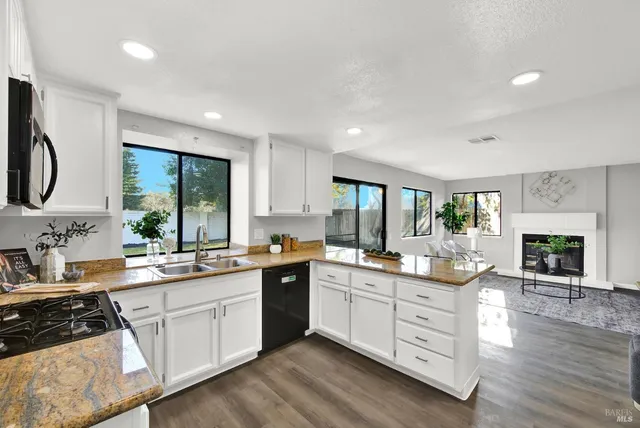 a kitchen with a sink stove and cabinets
