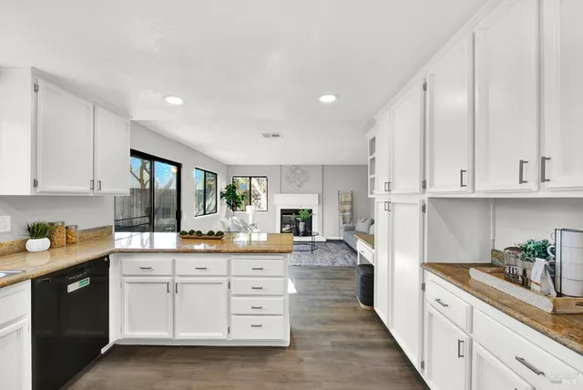 a kitchen with white cabinets and appliances