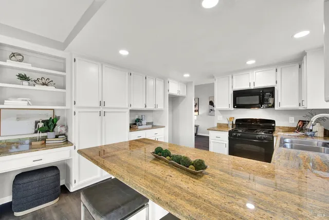 a kitchen with a sink stove top oven and refrigerator