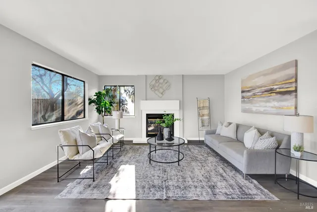 a living room with furniture a dining table and a potted plant
