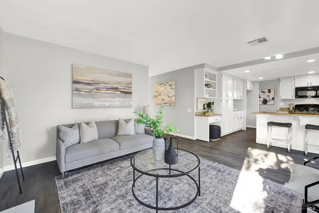 a living room with furniture and kitchen view