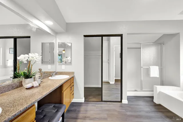a room with a granite countertop sink and a refrigerator