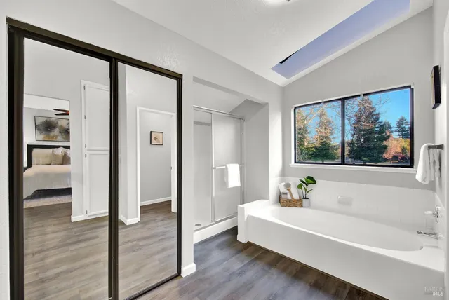 a bathroom with a bathtub and a shower