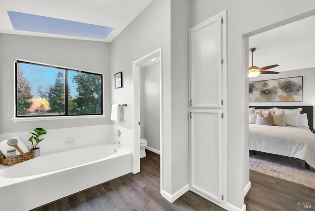 a bathroom with a bathtub and a window