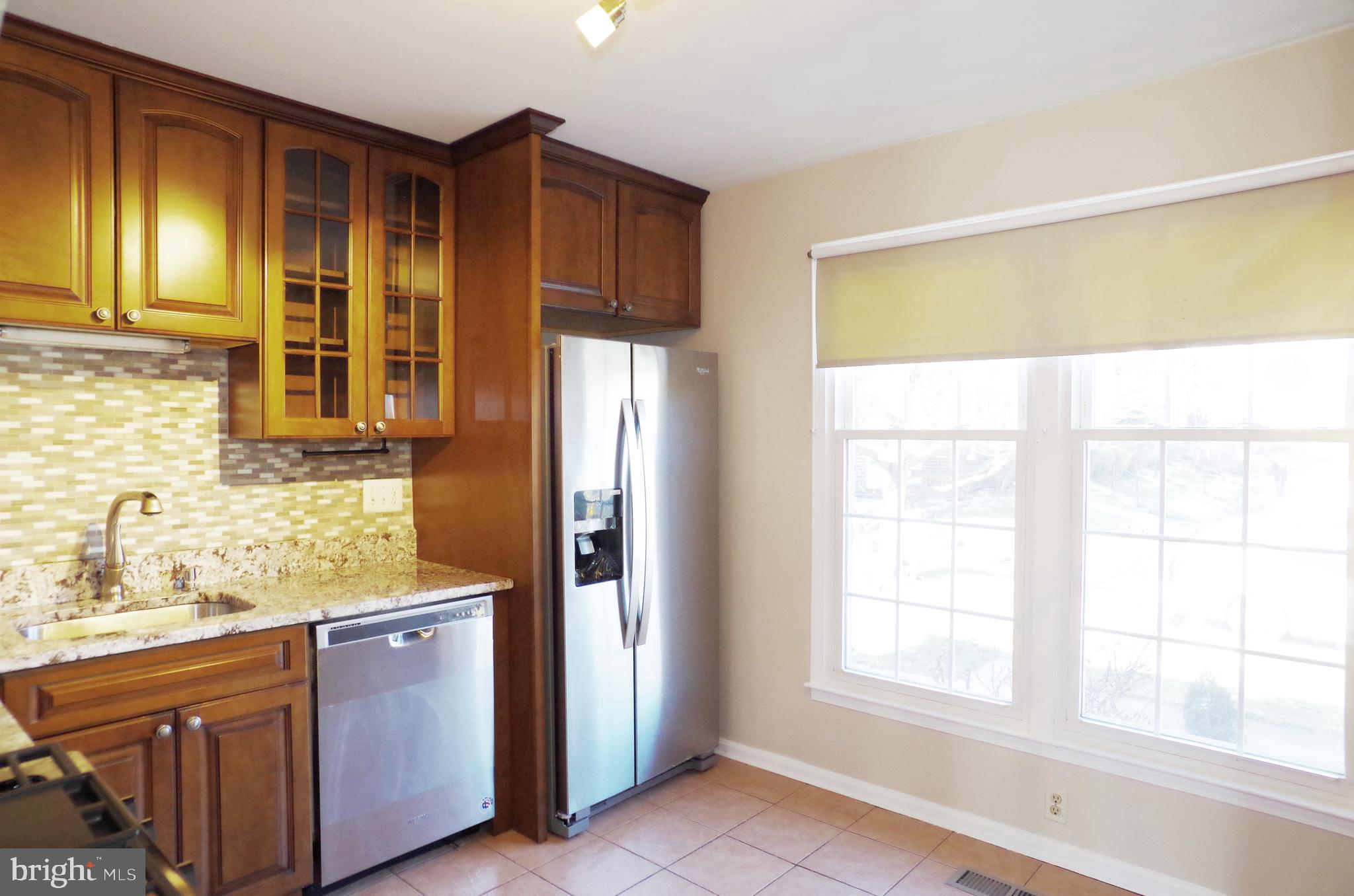 4492 Ruggles Court Annandale, VA 22003 - Photo 8 of 17 a kitchen with stainless steel appliances granite countertop a refrigerator and a sink