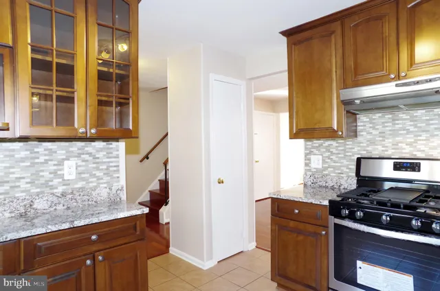 a kitchen with granite countertop cabinets and steel stainless steel appliances