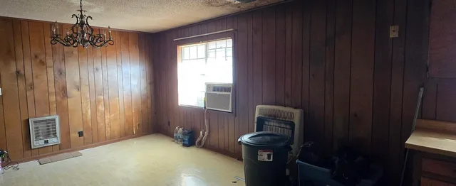 a view of a livingroom with furniture and chandelier fan