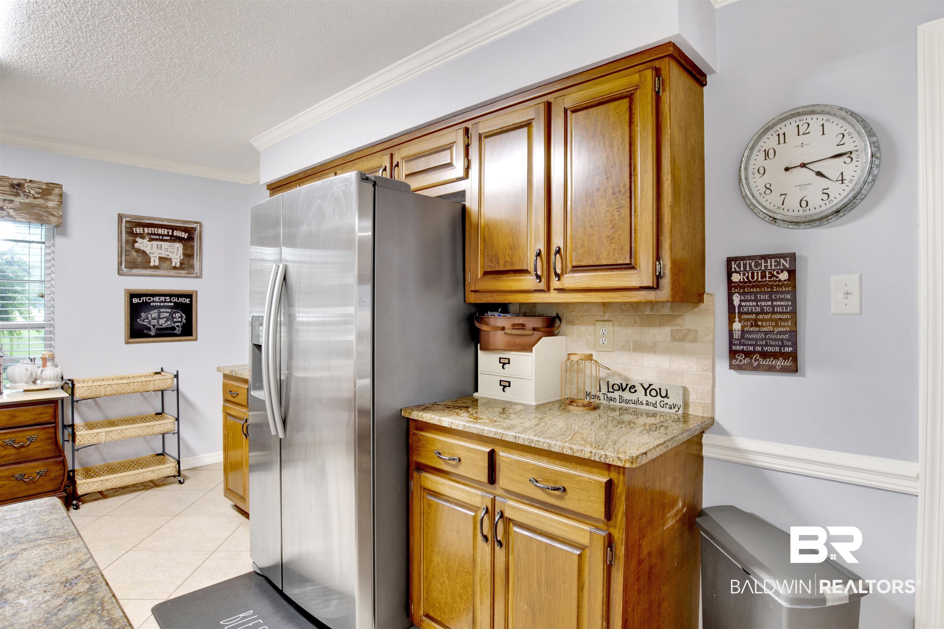 13385 Tom Gaston Road Mobile, AL 36695 - Photo 11 of 42 Kitchen with light tile patterned flooring, ornamental molding, a textured ceiling, backsplash, and stainless steel refrigerator with ice dispenser