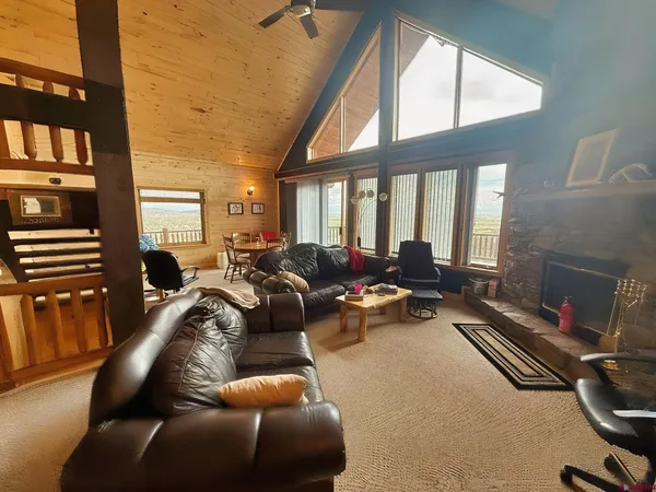 a living room with furniture fireplace and a large window